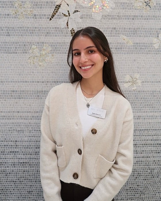Smiling woman in a cozy cardigan sweater.